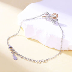 Rosévergoldetes Pavé-Schmuckset aus Sterlingsilber mit Zirkonia und gedrehter Schleife